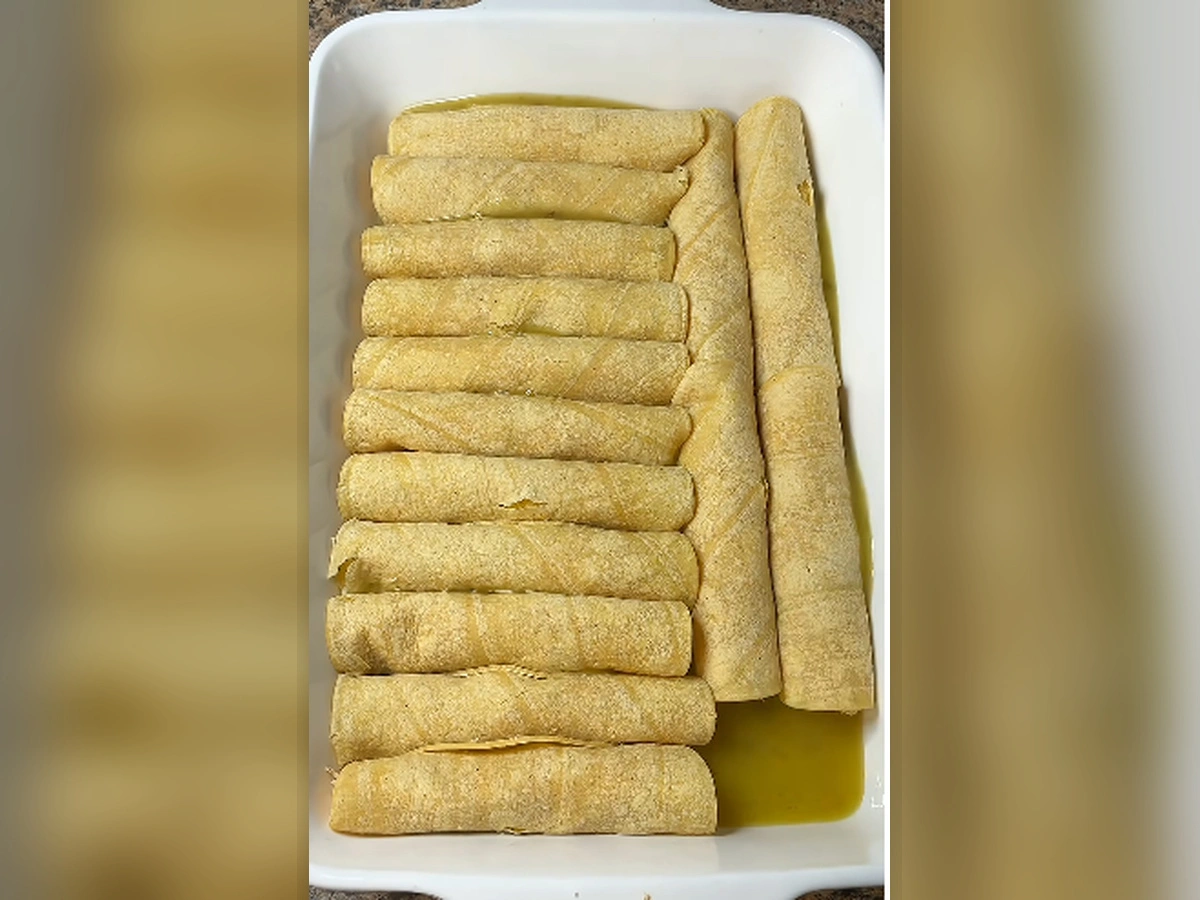 Green Chile Chicken Enchiladas – Easy, Creamy & Cheesy Dinner 2 text: Baked green chile chicken enchiladas with bubbling sauce and golden melted cheese, topped with cilantro